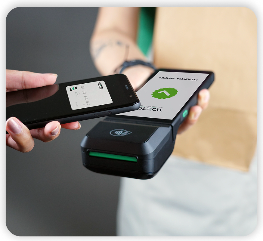 Customer paying by phone at a contactless ID TECH terminal